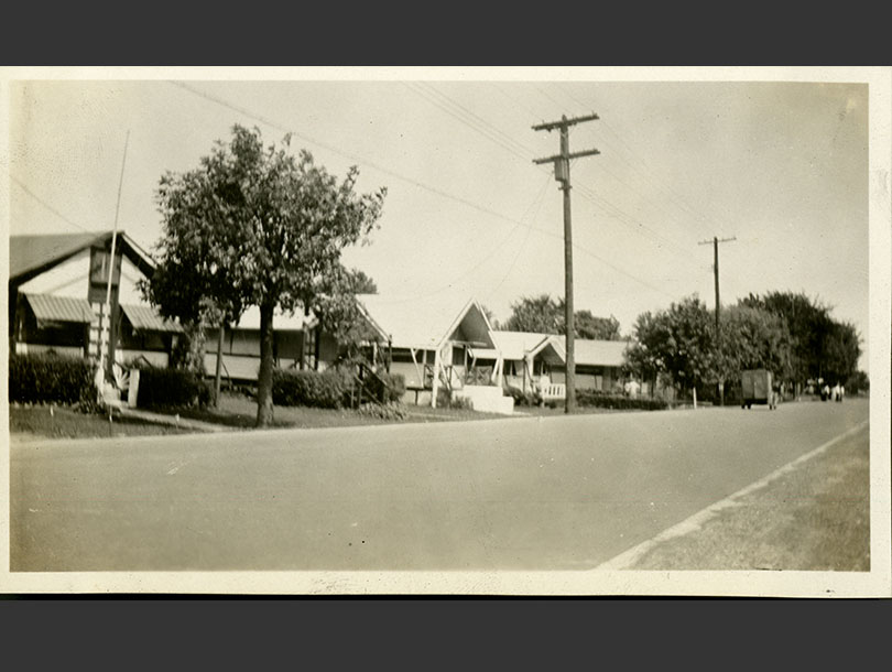 Street in Orchard Beach lined with 5 one-story houses.
