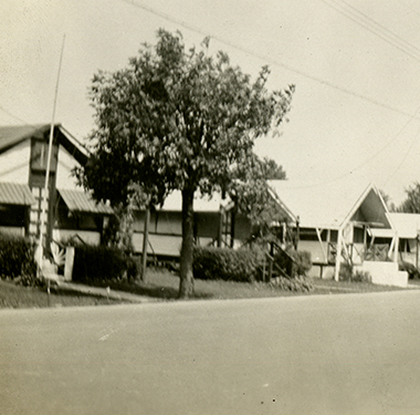 Street in Orchard Beach lined with 5 one-story houses.